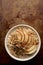 Apple Granola Porridge Bowl Top View on Brown Background Copy Space