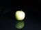 Apple. Green apple on black reflective studio background. black shiny mirror mirrored background for every concept.