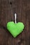 Apple green handmade fabric heart with polka dots hanging on an