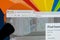 Apple iMac with Airbnb homepage on monitor screen under magnifying glass . Airbnb is online marketplace offering service to rent