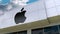 Apple Inc. logo on the modern building facade. Editorial 3D rendering