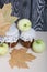 Apple jam in jars. Nearby are apples and dried maple leaves. Fruit harvest