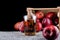 Apple juice and a box of red apples. Black background