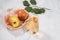 Apple juice in a glass glass, apples in a wicker plate on a light background.