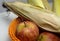 Apple and leafed corn on a blurred isolated background