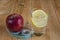 Apple with measuring tape and water drink with lemon