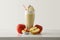 Apple milkshake with cream decorated with fruit on table isolated