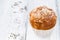 Apple muffin with icing sugar on white wooden background