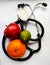 Apple,orange and lemon with stethoscope in white background