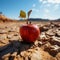 Apple on parched desert ground conveys food insecurity, water shortage, agricultural crisis