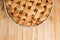 Apple pie in blue form on a light wooden background. Ready pie
