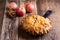 Apple pie in cast iron skillet on rustic wooden table