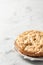 Apple pie Charlotte on white marbel background. Text space