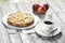 Apple pie, coffee cup and plate, apples on wood