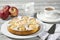 Apple pie, coffee cup and plate, apples on wood