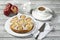 Apple pie, coffee cup and plate, apples on wood