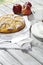 Apple pie, coffee cup and plate, apples on wood