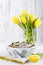 Apple pie in dishes on a white background and a bouquet of spring yellow tulips. Homemade pastries with fruit for a delicious