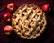 an apple pie with lattice on top and apples around it