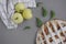 Apple pie with white towel on grey background. Dessert. Homemade cake with black tea and sieve. Autumn flatlay. Autumn homemade pi