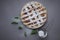 Apple pie with white towel on grey background. Dessert. Homemade cake with black tea and sieve. Autumn flatlay. Autumn homemade pi