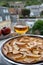 Apple products of Normandy, homemade baked apple cake and cider drink and houses of Etretat village on background, Normandy,