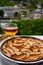 Apple products of Normandy, homemade baked apple cake and cider drink and houses of Etretat village on background, Normandy,