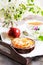 Apple rose shaped pie and cup of tea on the vintage serving tray