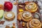 Apple roses pie with sugar powder. Traditional autumn baking, fall decor, flat lay