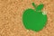 Apple shaped paper note on pinboard