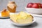 Apple slices near honey on grey marble table, closeup. Rosh Hashanah holiday