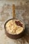 Apple Slices and Raisins on Porridge in Copper Saucepan