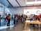 An Apple store with people waiting in line to purchase the latest Apple iPhone 11