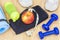 Apple with tape measure on towel with fitness equipment around