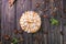 Apple tart with meringue and lime peel on a wooden stand