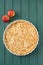 Apple tart with whole apples on turquoise stripped background