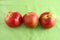 Apple trio on green cloth background