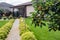 Apples on apple tree and Green area around a house. Modern Garden landscape design with  path