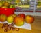 Apples from an apple tree on a wooden kitchen counter along a window in autumn