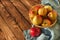 Apples apple in a woven vase blue towel on a wooden table close up