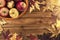 Apples basket and maple leaves disposed on a wooden table.