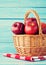 Apples in a basket over turquoise wood