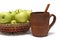 Apples in basket and potter mug
