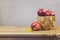 Apples in basket on wooden table. Fresh farm products