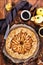 Apples and cinnamon rustic open pie galette, top view