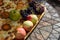 apples and grapes left on a tray on a tile tables