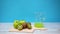 Apples and kiwi fruits appear on cutting board and jug filling with juice - Stop motion