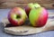 Apples large, red, green are on a wooden surface