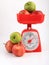 Apples on red weighing scale