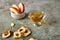 Apples slices in bowl, chips and juice on wooden background